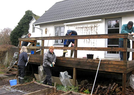 En terrasse gøres forårsklar med fælles hjælp